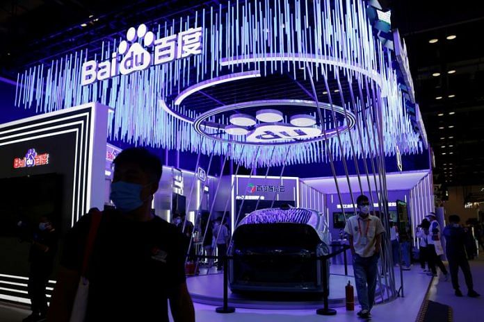 People walk past an Apollo vehicle displayed at the Baidu booth during the 2021 China International Fair for Trade in Services in Beijing | Reuters file photo