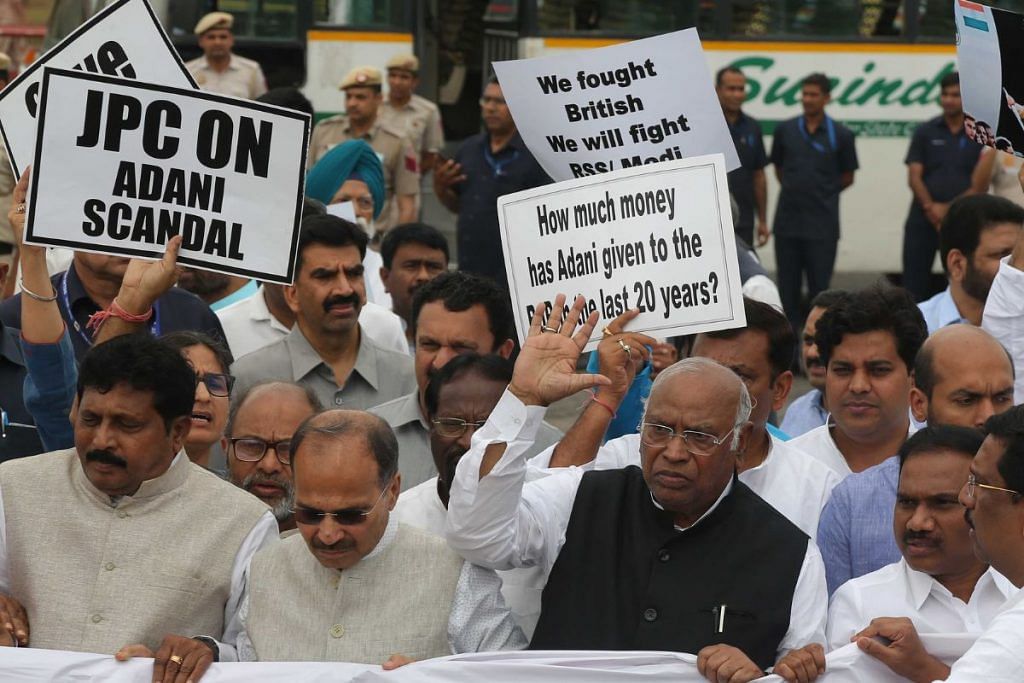 Congress President Mallikarjun Kharge, along with MPs of other opposition parties, holds a "Democracy in Danger" banner during a protest march towards Rashtrapati Bhawan in New Delhi on 24 March | Photo: Suraj Singh Bisht/ThePrint