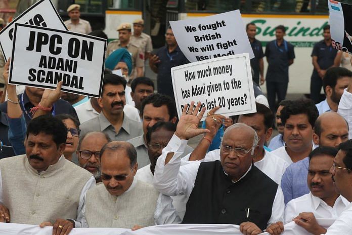 Congress President Mallikarjun Kharge, along with MPs of other opposition parties, holds a 