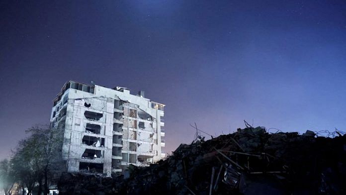 A destroyed building is seen at night, in the aftermath of a deadly earthquake, in Antakya, Hatay province, Turkey on 21 February, 2023 | Reuters