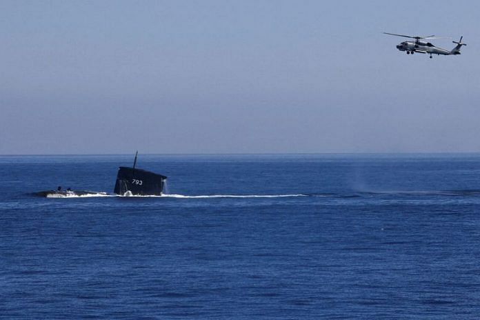 A S70C helicopter can be seen flying around SS793 submarine off Taiwan's northeastern coast in Yilan | Reuters