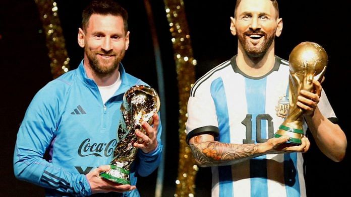 File photo of Argentina's Lionel Messi poses with a statue of himself holding the World Cup during the Conmebol event on 27 March, 2023 | Reuters