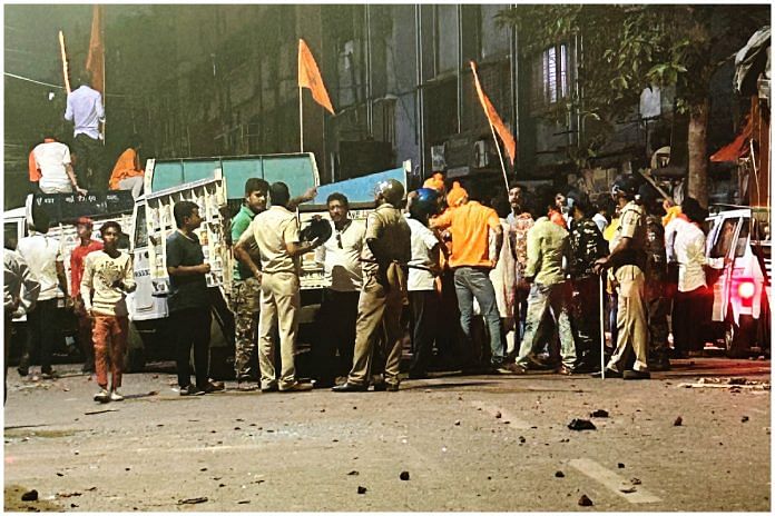 Police personnel and participants of Ram Navami procession at Shibpur on Thursday evening | Sreyashi Dey | ThePrint