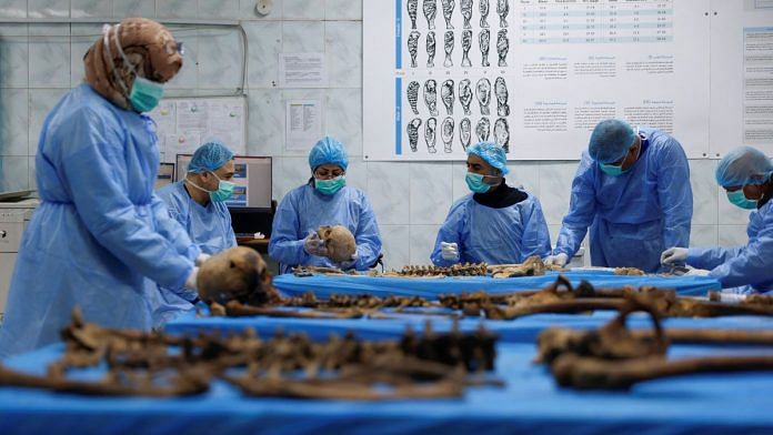 FILE PHOTO-A team works to identify remains exhumed from a mass grave in the mass grave section of the medico-legal directorate of Iraq's ministry of health, in Baghdad,Iraq, January 30, 2023. REUTERS/Ahmed Saad