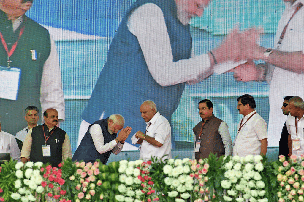 PM Narendra Modi greets former Karnataka Chief Minister BS Yediyurappa at the inauguration and laying of the foundation stone of multiple projects, in Shivamogga on 27 February. | ANI