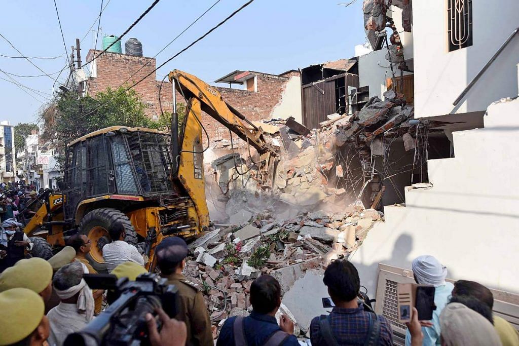 A bulldozer demolishes the house of Zafar Ahmad, a close aide of Atiq Ahmed, in Prayagraj on Wednesday | ANI