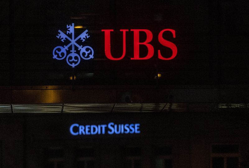 Logos of Swiss banks UBS and Credit Suisse are seen on an office building in Zurich, Switzerland | Reuters
