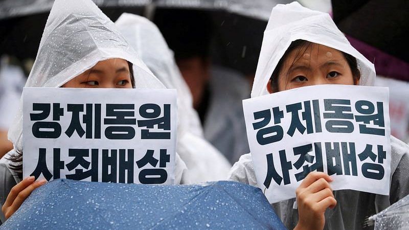 Women hold signs that read "Compensate and apologize for victims of wartime forced labour" during an anti-Japan protest on Liberation Day in Seoul, South Korea | File Photo: Reuters