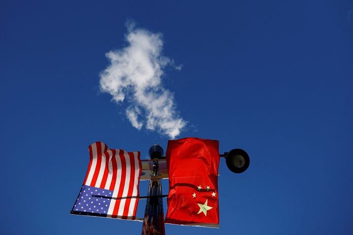 The flags of the United States and China fly from a lamppost in the Chinatown neighborhood of Boston, Massachusetts | Reuters file photo