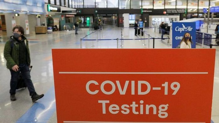 File photo of a sign advertising coronavirus disease testing ahead of the Thanksgiving holiday at Logan International Airport in Boston, Massachusetts, on 22 November, 2021 | Reuters