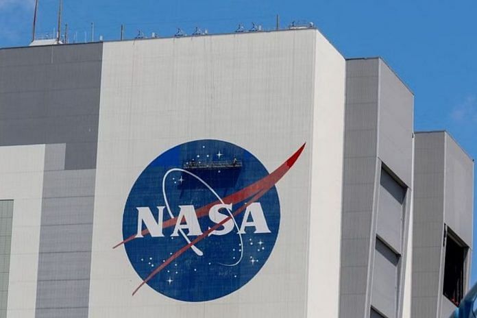 File photo of workers pressure wash the logo of NASA on the Vehicle Assembly Building at the Kennedy Space Center in Cape Canaveral, Florida, 19 May, 2020 | Reuters