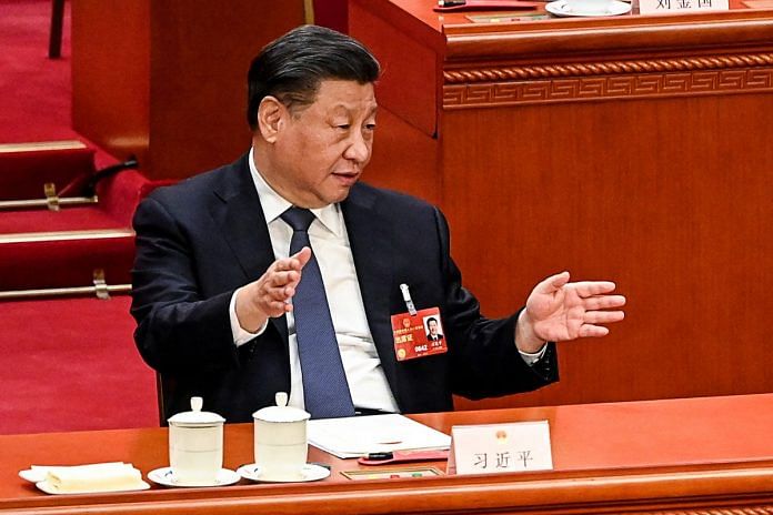 File photo of China's President Xi Jinping speaking with other leaders during the fourth plenary session of the National People's Congress (NPC) at the Great Hall of the People in Beijing on 11 March, 2023 | Reuters