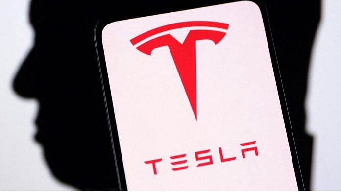 Tesla logo and Elon Musk silhouette are seen in this illustration taken, on 19 December, 2022 | Reuters
