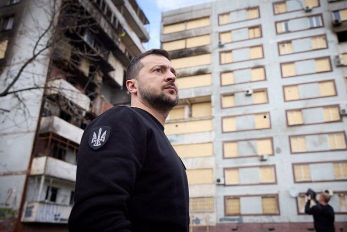Ukraine's President Volodymyr Zelenskyy visits a site of residential buildings recently damaged by a Russian missile strike, amid Russia's attack on Ukraine, in Zaporizhzhia on 27 March, 2023 | Reuters