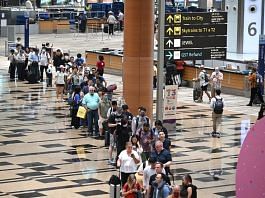 Passengers queue at the departure hall of Changi Airport Terminal 3 in Singapore March 31, 2023. Lim Yaohui /SPH/The Straits Times/via REUTERS