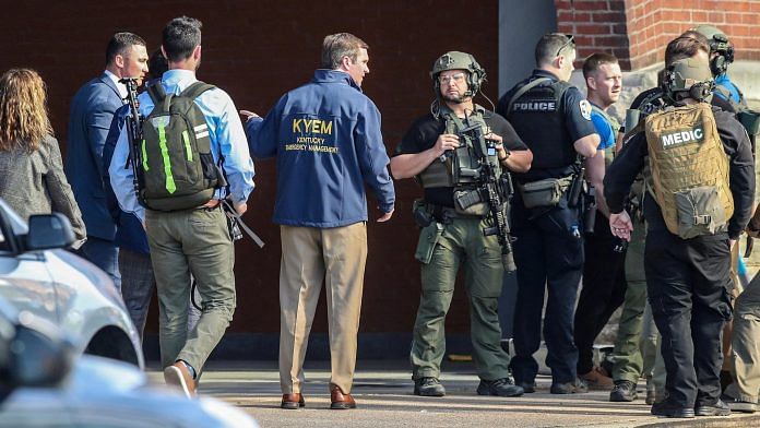 Kentucky Governor Andy Beshear speaks with police deploying at the scene of a mass shooting near Slugger Field baseball stadium in downtown Louisville, Kentucky, on 10 April, 2023 | Reuters