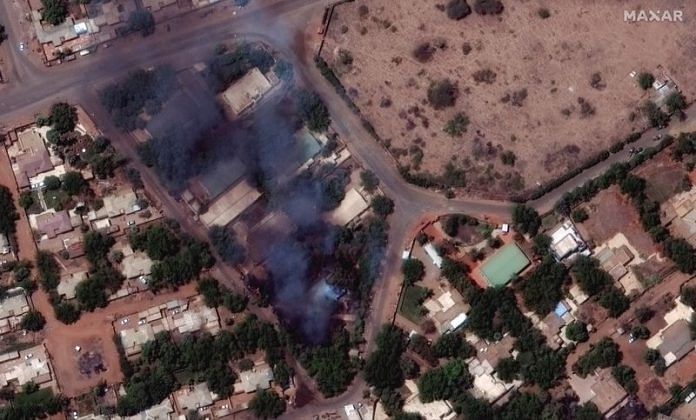 A satellite image shows burning buildings and military patrol northeast of Khartoum International Airport in Khartoum, Sudan | Courtesy of Maxar Technologies/Handout via Reuters