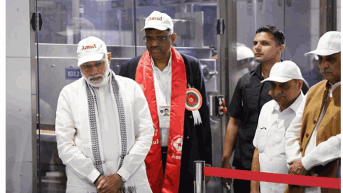 File photo of PM Narendra Modi while visiting the cooperative's chocolate plant at Anand, Gujarat. Amul MD Jayen Mehta is behind the PM | Twitter: @narendramodi