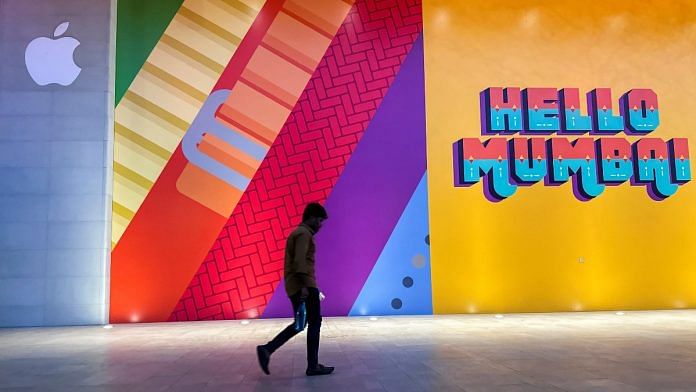 A man walks past the barricade of India's first Apple retail store at Jio World Drive Mall in Mumbai | Reuters