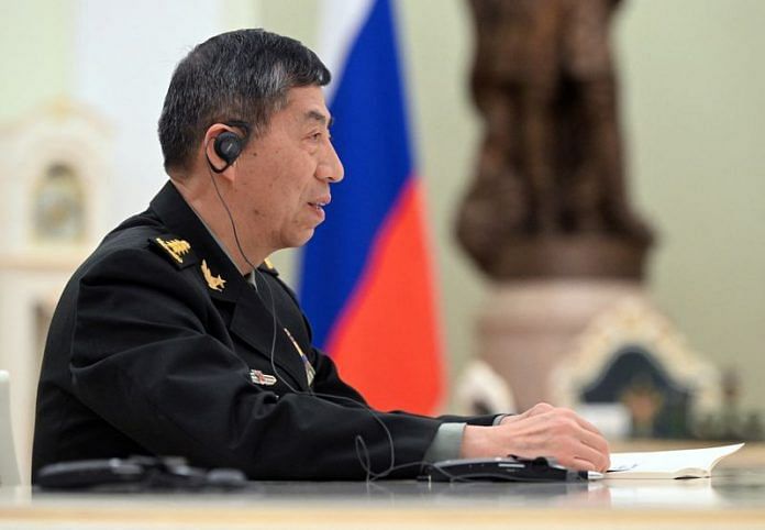 Chinese Defence Minister Li Shangfu attends a meeting with Russian President Vladimir Putin and Defence Minister Sergei Shoigu in Moscow, on 16 April 2023 | Sputnik/Pavel Bednyakov/Pool via Reuters