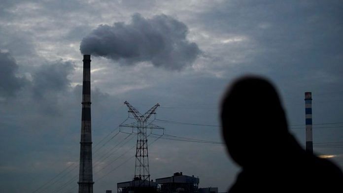 A man walks past a coal-fired power plant in Shanghai, China | File Photo: Reuters