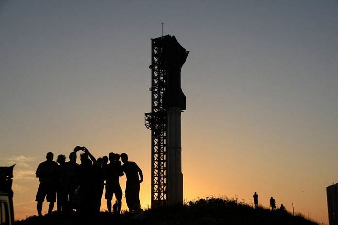 Tourists take photos at sunset of SpaceX's Starship the day before it launches from the Starbase launchpad on an orbital test mission, in Boca Chica, Texas | Reuters