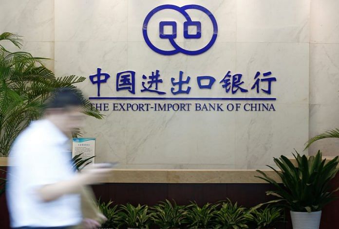 A man walks past the lobby of the Export-Import Bank of China (EXIM) headquarters in Beijing | Reuters file photo