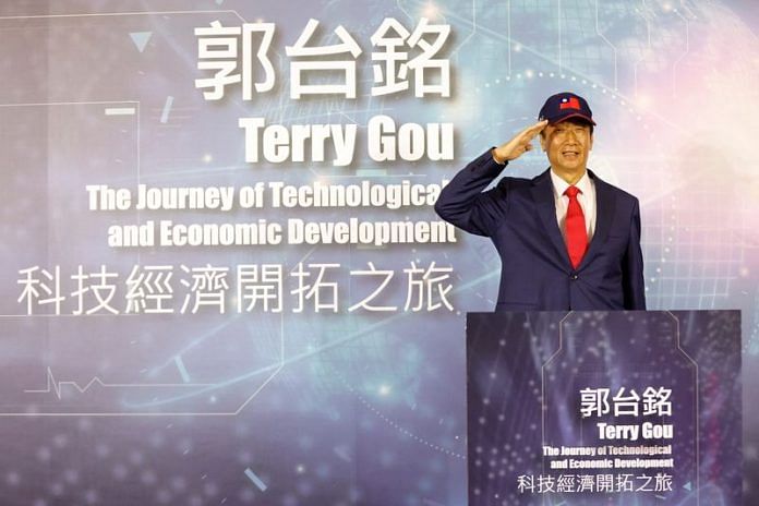 Terry Gou, founder of Taiwan's Foxconn poses for pictures while saluting during a news conference in Taoyuan, Taiwan, on 5 April 2023 | Reuters