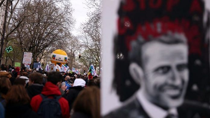 Protesters hold a drawing depicting a portrait of French President Emmanuel Macron during a demonstration in Paris | File Photo: Reuters