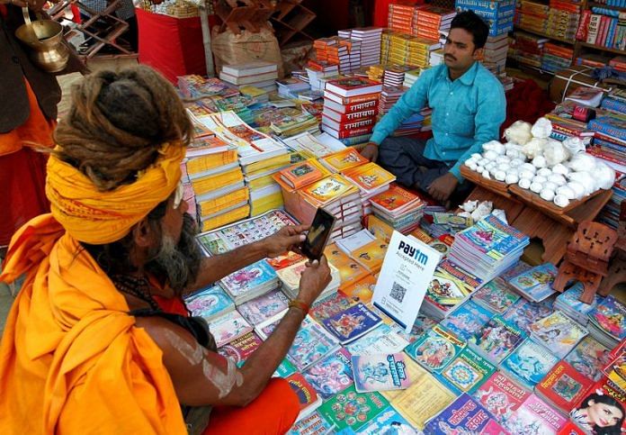 A Sadhu or a Hindu holy man pays the vendor through Paytm | Reuters file photo