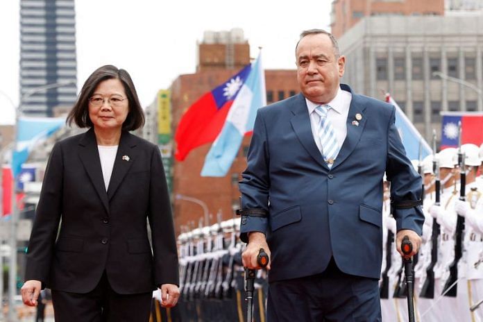 Taiwan's President Tsai Ing-wen walks next to Guatemala's President Alejandro Giammattei during his welcome ceremony in front of the Presidential building in Taipei, on 25 April 2023 | Reuters