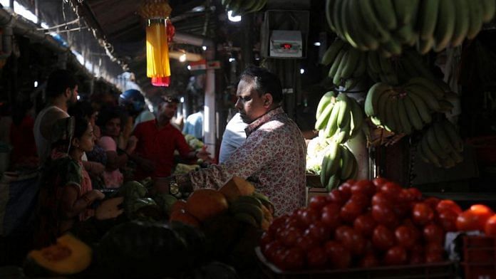 A fruit vendor tends to customers at a fruit and vegetable wholesale market in Mumbai | File Photo: Reuters
