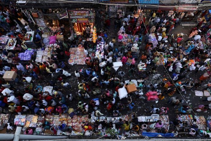 People shop at a crowded market in the old quarters of Delhi | Reuters