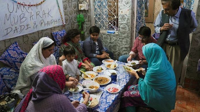 Members of a Muslim family sit down for a meal in an old quarter of Delhi | File Photo: Reuters