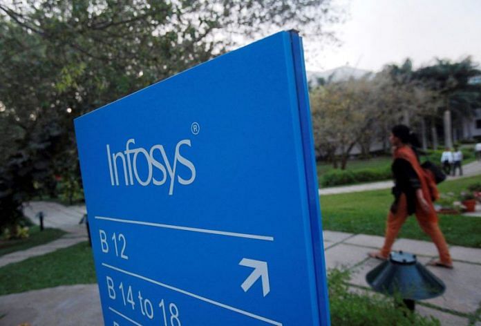 An employee walks past a signage board in the Infosys campus at the Electronics City IT district in Bangalore | Reuters file photo