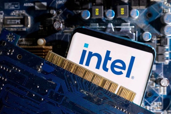 A smartphone with a displayed Intel logo is placed on a computer motherboard in this illustration | Reuters