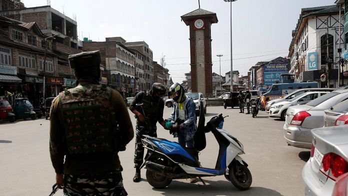 CRPF personnel check the bags of a scooterist as part of security checking in Srinagar | Reuters file photo