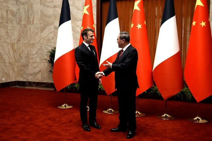 France's President Emmanuel Macron is welcomed by Chinese Premier Li Qiang prior to a meeting at the Great Hall of the People, in Beijing, on 6 April 2023 | Thibault Camus/Pool via Reuters