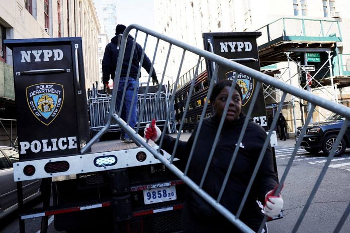A person holds a barricade outside the Manhattan Criminal Court in New York City | Reuters/Andrew Kelly