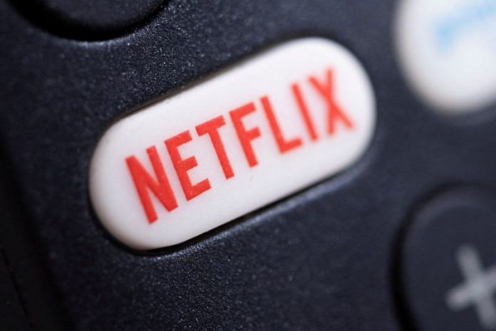 The Netflix logo is seen on a TV remote controller | Reuters