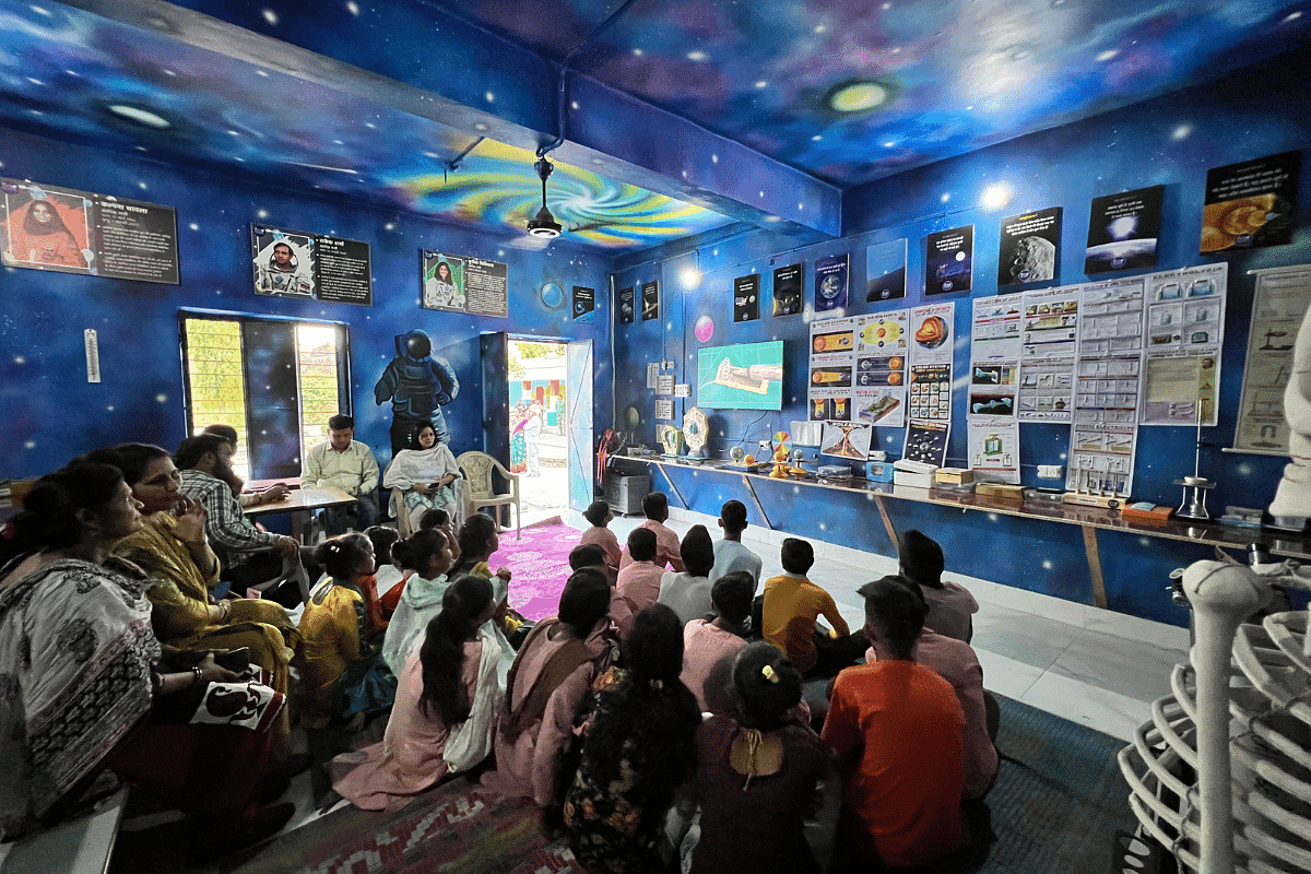 Students and their friends, and teachers, of Faisal Parmanand school watching an instructional YouTube video on basic physics experiments | Sandhya Ramesh/ThePrint