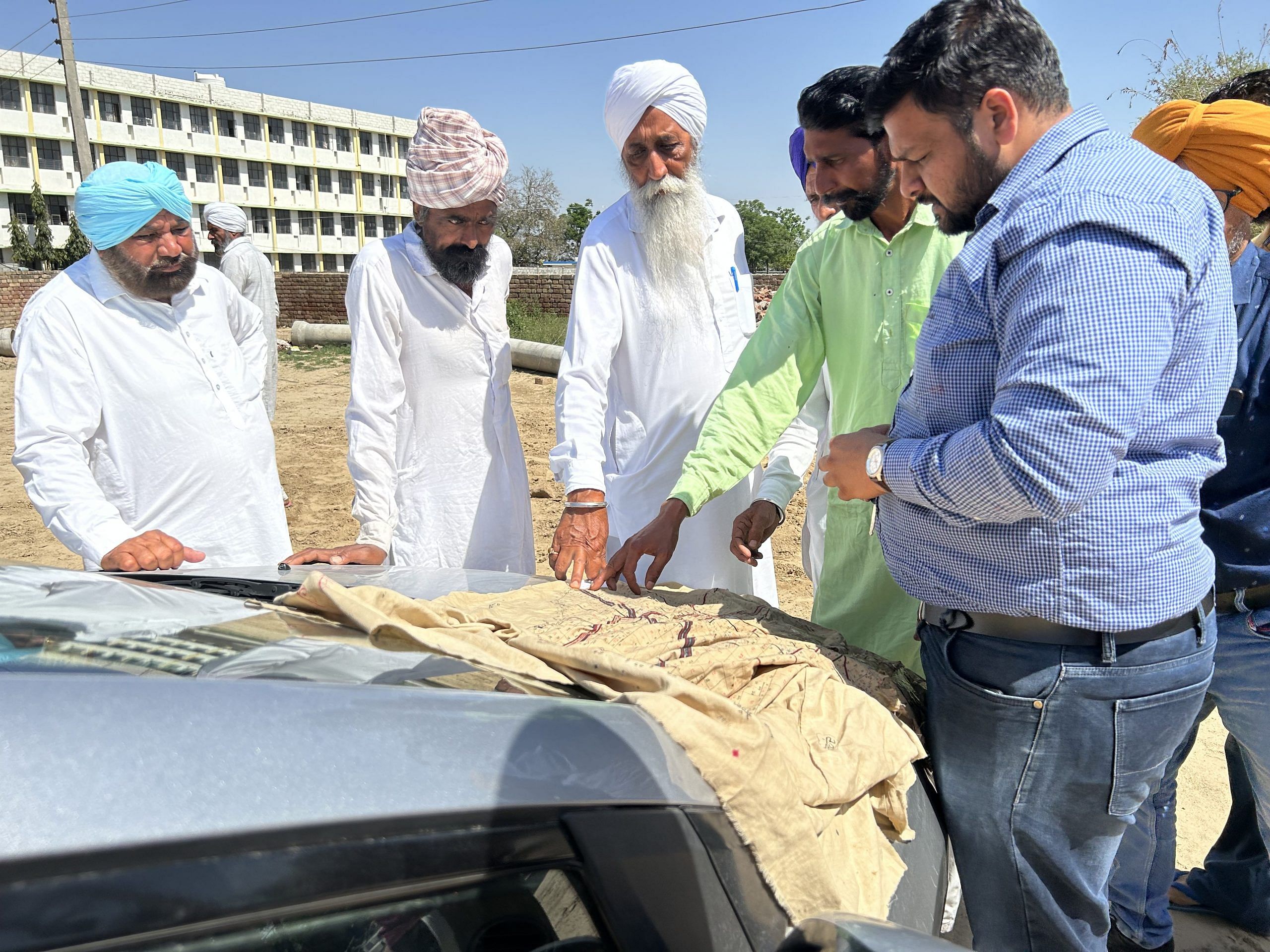 The patwari of the village Killi Nihal Singh Wala using a canvas map to lay out his route for the girdawari | Photo: Nikhil Rampal | ThePrint