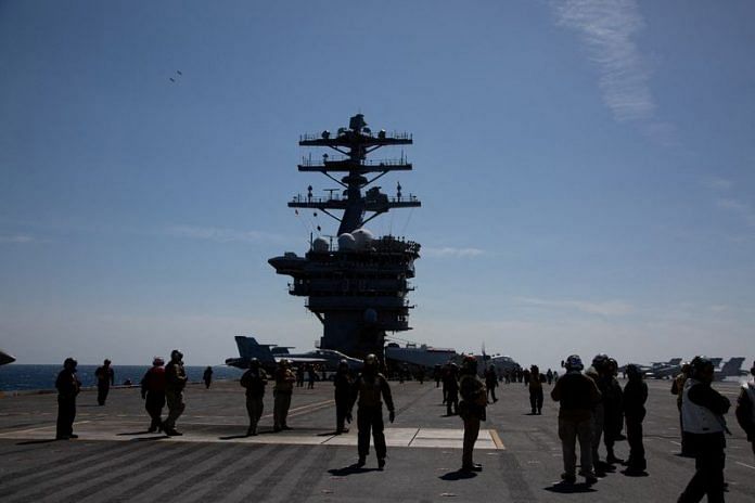 Crews are seen on the flight deck of the USS Nimitz, off the coast of Busan, South Korea, on 27 March 2023 | Pool via Reuters