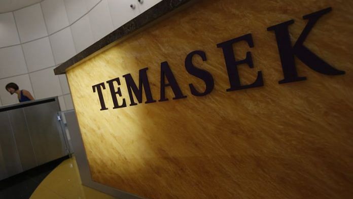 A woman passes a logo of state investor Temasek Holdings at their office in Singapore | File Photo: Reuters
