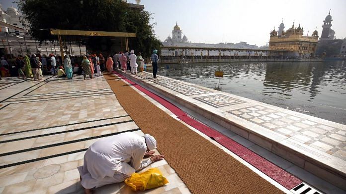 File image of a devotee offering prayers at the Golden Temple in Amritsar| ANI