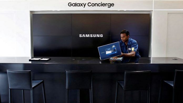 A worker cleans a Samsung showroom in New Delhi | File Photo: Reuters