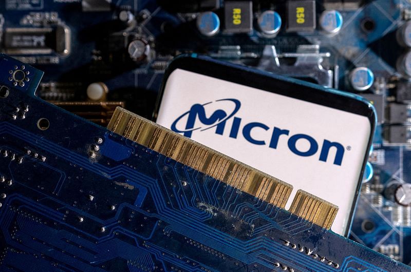 A smartphone with a displayed Micron logo is placed on a computer motherboard in this illustration | Reuters