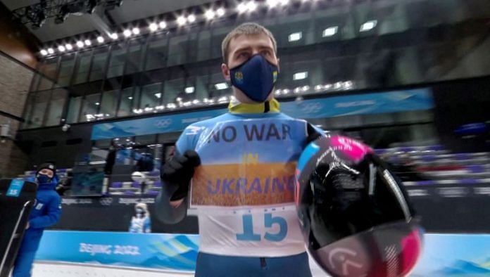 Vladyslav Heraskevych of Ukraine holds a sign with a message reading 'No war in Ukraine' | IOC/OBS/Handout via Reuters