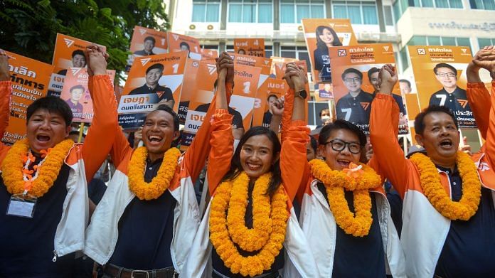 Chonthicha 'Lookkate' Jangrew, an activist-turned-election candidate for the Move Forward Party, reacts with other candidates during the upcoming election campaign in Pathum Thani, Thailand | Reuters