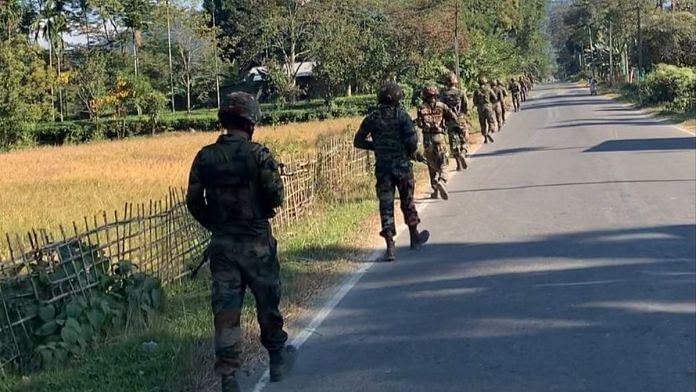 Troops patrol a road in Tinsukia